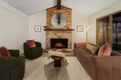 Living Room: Enjoy lively conversations by the warm fireplace in this stylish, inviting space!