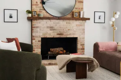 Living Room Retreat: Enjoy a chic space with vintage charm and a warm brick fireplace!