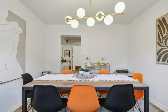 Dining Room: Vibrant design with chic lighting sets the stage for memorable meals together!