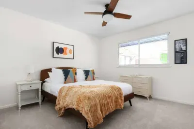 Charming Queen Bedroom: Vibrant decor, warm lighting, and great views ensure relaxing nights in style!