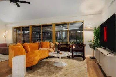 Living Room: Vibrant hues and sleek decor invite relaxation and movie nights with stunning views!