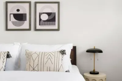 Bedroom Bliss: Modern art and plush pillows await in your serene Austin retreat!