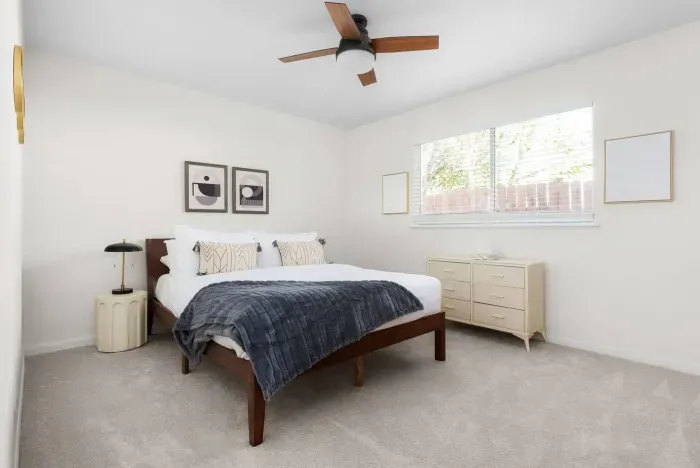 Serene Queen Bedroom Retreat: Enjoy restful nights in a bright space with stylish decor and modern comfort!