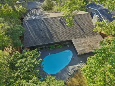 Outdoor Oasis: Dive into relaxation by the sparkling pool surrounded by lush greenery!