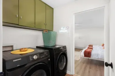 Laundry Room: Stylish machines and vibrant decor make laundry day a snap in this charming space!