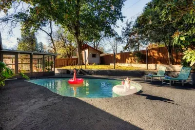 Backyard Oasis: Dive into fun with a vibrant pool and playful floats in your private retreat!
