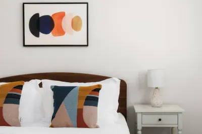 Dreamy Bedroom: Stylish decor and vibrant pillows invite relaxation after Austin adventures!
