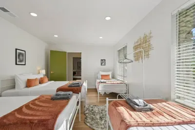 Bright and Welcoming Room: Perfect for group fun with spacious beds and natural sunlight!