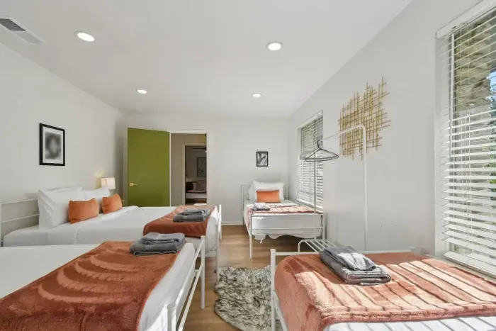 Bright and Welcoming Room: Perfect for group fun with spacious beds and natural sunlight!