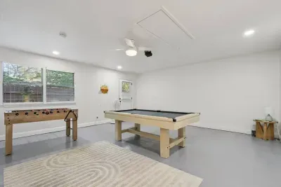 Game Room: Enjoy friendly competitions around the sleek pool table or foosball! We also have a movie projector for theme and film nights - Fun awaits!