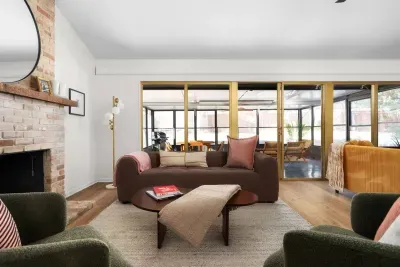 Living Room Oasis: Bright, airy space with chic decor and views of a vibrant screened patio!