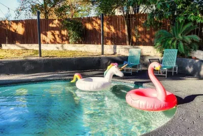 Poolside Oasis: Dive into fun with playful floats and vibrant outdoor seating!