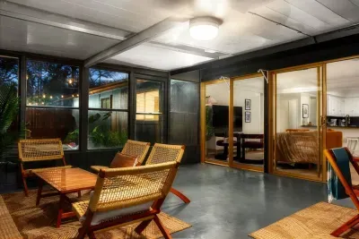 Sunroom Sanctuary: Relax with friends amid stylish seating and twinkling evening lights!