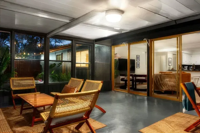 Sunroom Sanctuary: Relax with friends amid stylish seating and twinkling evening lights!
