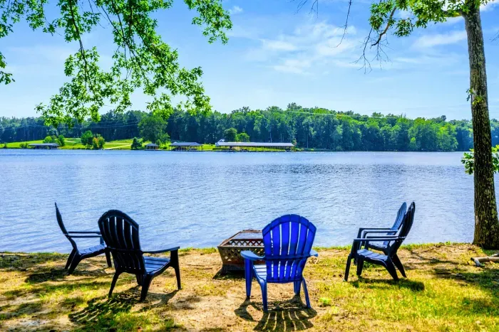 Fire Pit Area - Colorful Adirondack chairs surround the lakeside fire pit, perfect for evening gatherings under the stars.