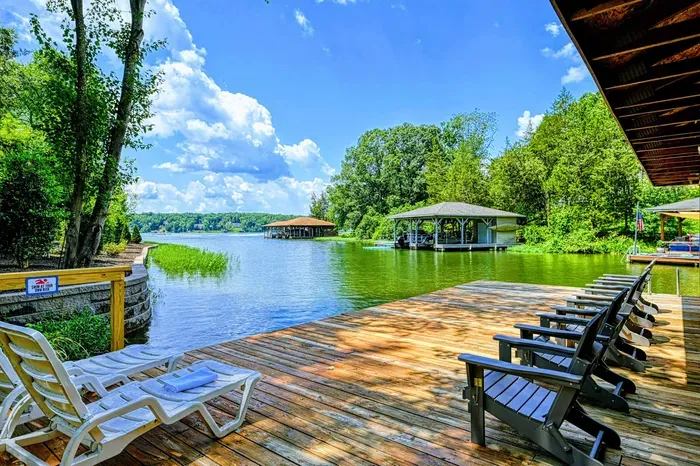 Dock - Adirondack lounge chairs line the sundeck with views across the cove and neighboring docks.