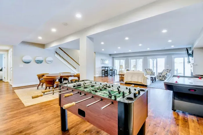 Fun entertainment area featuring foosball, air hockey, and comfortable seating with lake views