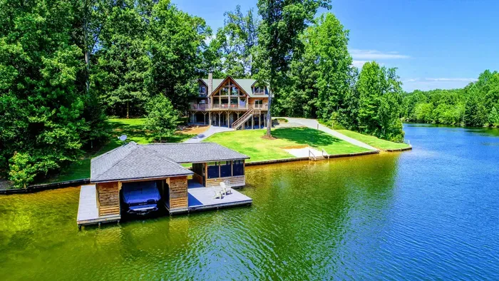 Stunning waterfront retreat with a private dock and serene wooded surroundings.