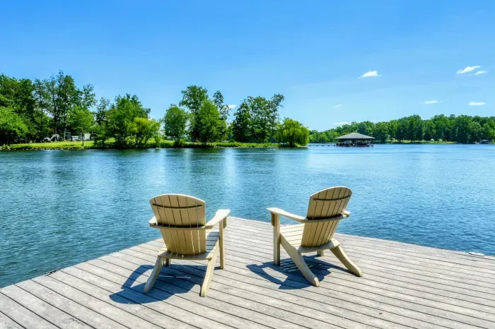 Peaceful dockside seating with Adirondack chairs offering stunning views of the serene lake.