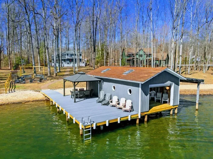 Aerial Dock - The deck, gazebo, Adirondack seating, and swim ladder are all visible from above, with the lake stretching out on all sides.