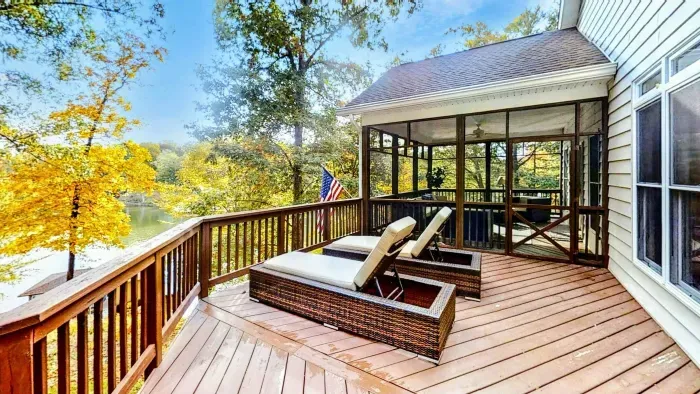 Relax in style at this stunning lakeside retreat, featuring a spacious deck with lounge chairs, a screened-in porch, and breathtaking waterfront views.