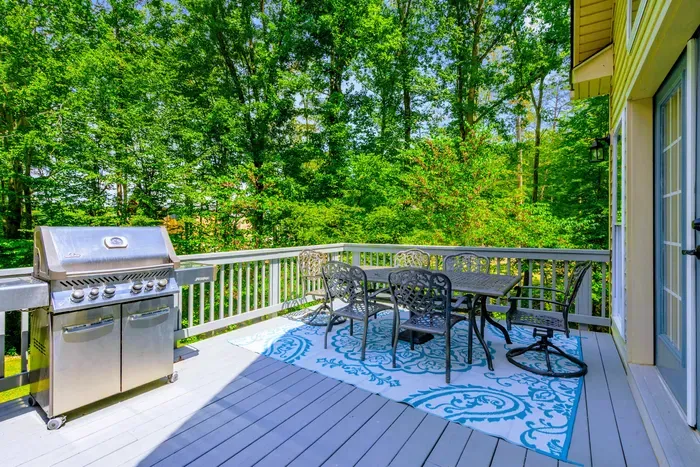 Multi-level decks wrap the back of the home, connecting every floor to the lake views and the yard below.