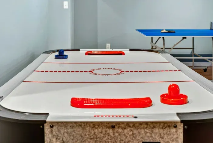 Air hockey in the lower level game room. When the sun goes down or the weather rolls in, the fun keeps going.