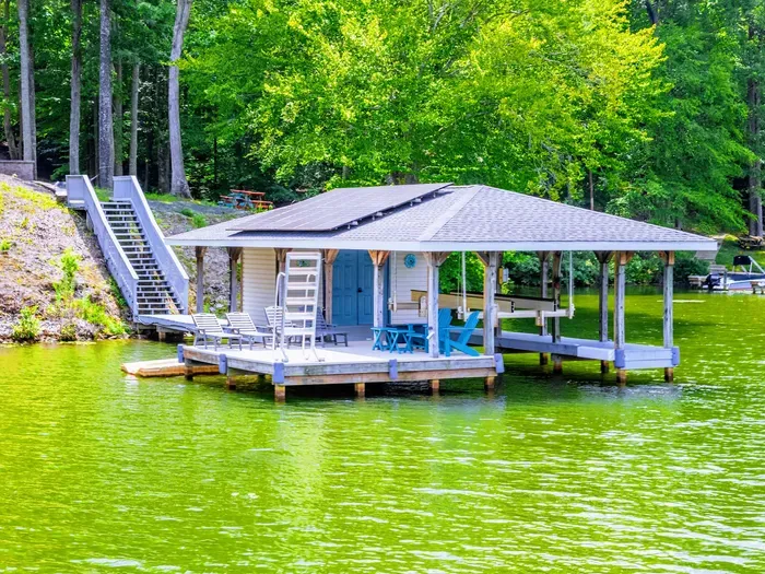 Your morning starts here: coffee in hand, bare feet on the dock, the lake still and golden before the boats come out.
