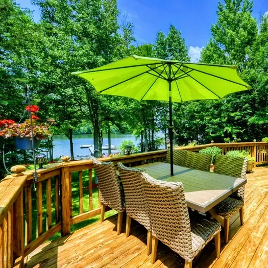 Vibrant Lakeside Lounge – Enjoy comfortable seating under bright green umbrellas on this spacious deck with stunning views of Lake Anna. Perfect for relaxation or lively conversations in a pic
