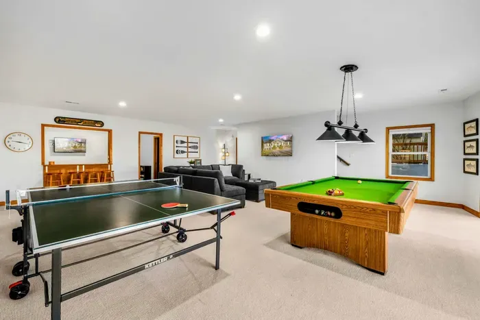 Game Room – This versatile game room, located on the lake level, is a hub for entertainment and relaxation. Featuring a pool table, ping pong table, and comfortable seating area, it's perfectly equipped for fun evenings and rainy day activities.
