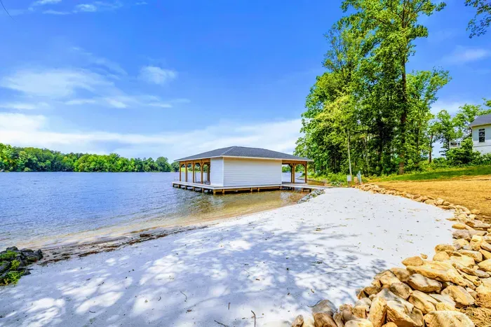 Backyard - A sandy shoreline with gentle water makes it simple to swim, wade, and play while the group relaxes just steps away.