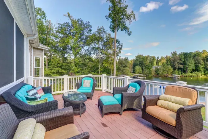 Upper Terrace - Teal sectionals around the gas fire pit with a wide cove view, the prime sunset spot.