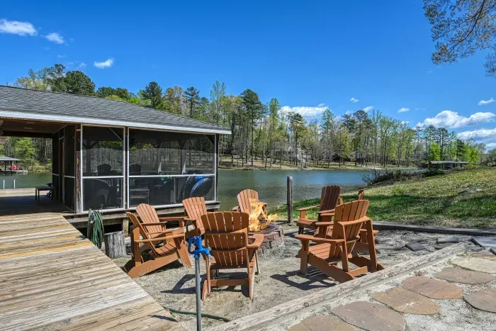 Dock - Adirondacks circle the patio fire pit just off the dock pier, signature waterfront seating.