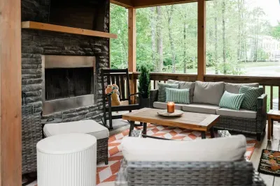 Step from the dining room to the cozy covered porch retreat—perfect for morning coffee, bird songs, or curling up by the fireplace while staying connected to the heart of the home