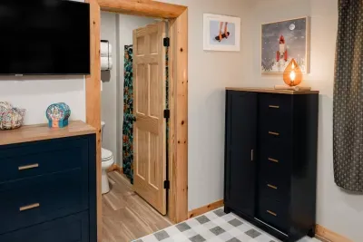 Convenience meets camp: the bunk room’s ensuite doubles as the hall bath for the Deer Den, so no midnight treks needed... just easy comfort for kids and grown-ups alike