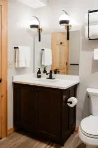 A cheerful vanity with playful sconces keeps the camp spirit alive while offering plenty of space to brush teeth, braid hair, or prep for the day’s adventures