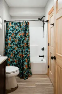 Perfect for little campers, the tub-shower combo in the basement hall / bunk room bathroom makes bath time easy after lake swims, trail hikes, or bunk room adventures