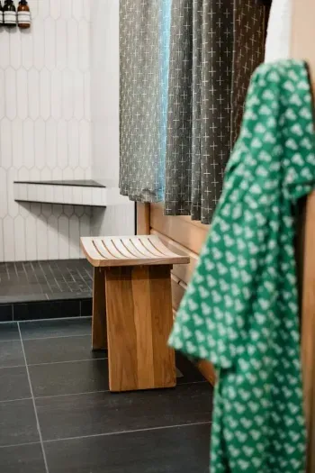 Vintage finds meet modern comfort.  The main floor ensuite bath is styled with playful details & nostalgic nods with thoughtful touches for an easy, relaxing stay