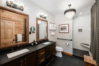 Double vanities, warm wood, and a spacious shower make this master bath a retreat all its own—because adventure feels better when you can unwind in style