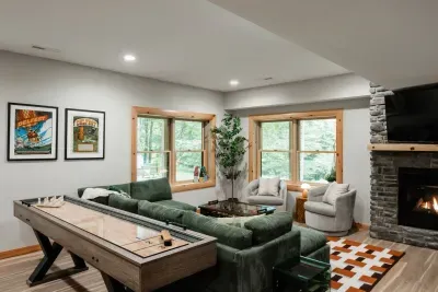 The Deer Den: a full second great room downstairs, complete with shuffleboard, foosball coffee table, a gas fireplace, and plenty of cozy seating for late-night hangs