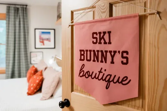 “Ski Bunny’s Boutique” brings a touch of après-ski glamour to the mountains.  Where soft pinks meet playful sparkle, and every detail, from marble tables to the mirror ball mushroom, proves that cozy can still shine