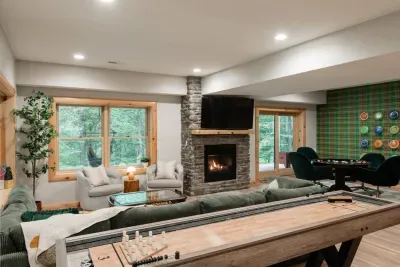 Plenty of room to spread out — TV and fireplace on one side, games and plaid walls on the other