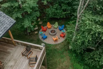 An aerial view of your private retreat: rocking chairs on the deck, a firepit below, and the forest wrapping it all in calm. It’s the perfect backdrop for morning coffee, evening stories, and the simple joy of being together