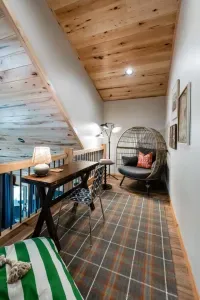 A cozy perch under the eaves: catch up on work, share a puzzle, or curl into the egg chair with a book while still part of the campfire-style chatter downstairs