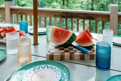 Summer is sweeter when shared. From watermelon slices to family-style dinners, the deck’s picnic table transforms meals into memories. It’s where conversation lingers long after the plates are cleared