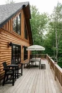 Perched high among the trees, the deck invites connection and quiet. Share a meal at the picnic table, then drift to one of the cozy chair pairings for conversation, coffee, or simply soaking in the forest canopy