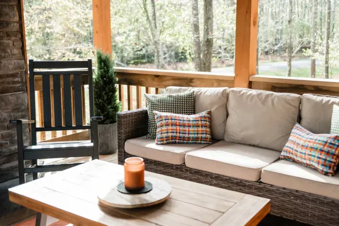 Morning coffee or golden-hour cocktails — the covered porch is where the day slows down. With its rocking chair, layered textures, and forest backdrop, it’s Camp Kindred’s quiet invitation to linger a little longer