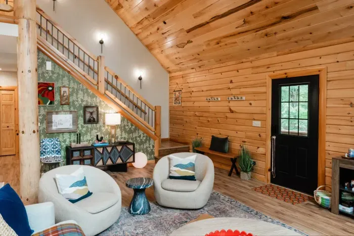 From the moment you walk in, the cabin’s personality shines: toile-inspired wallpaper with forest critters (real + cryptid), layered textiles, and curated artwork that sparks curiosity. Settle in and let the space invite connection and discovery