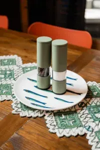 Even the details at the table are thoughtful... playful touches, bold colors, and everything you need to season meals shared around the farmhouse table