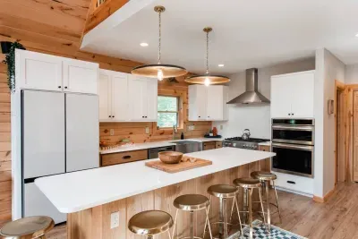 Every detail in this kitchen is designed for connection: double ovens for holiday feasts, a gas range for comfort meals, and a generous island where conversations flow as easily as the water pitcher in the refrigerator